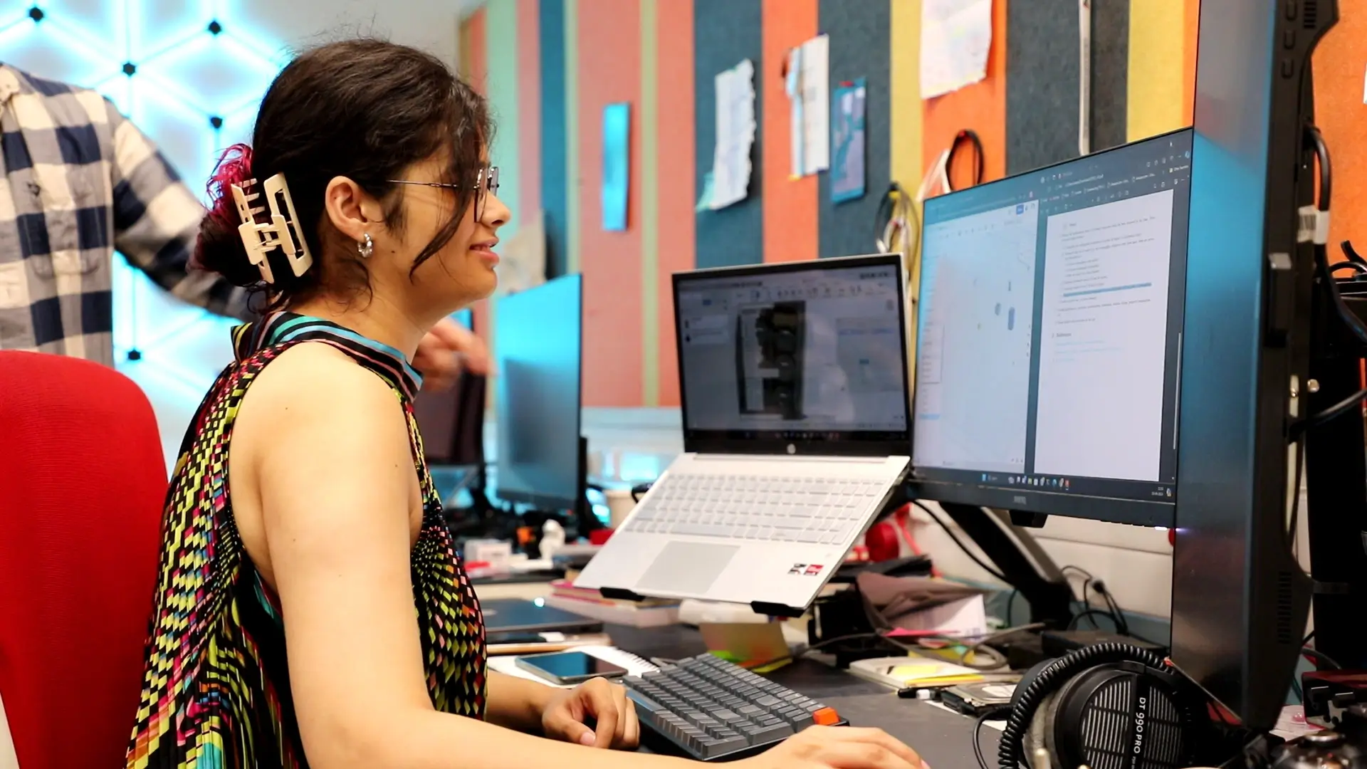 A Digital Health and Responsible AI student working at a multi-monitor research desk