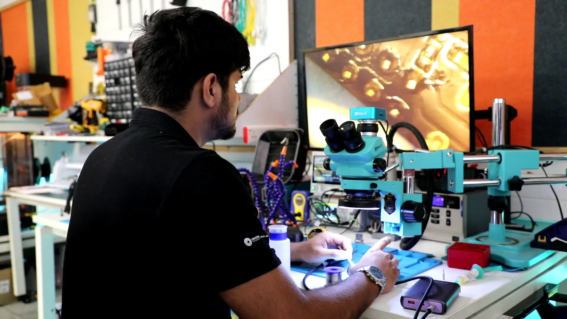 A Human Health and Immunology student examining a sample under a lab microscope